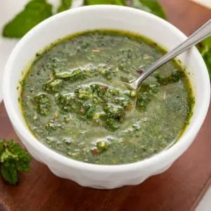 Bowl of mint chimichurri on a platter.