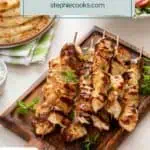 Grilled chicken skewers on a wooden platter. Text overlay includes recipe name.