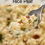 Fork holding up a bite of almond rice pilaf. Text overlay includes recipe name.