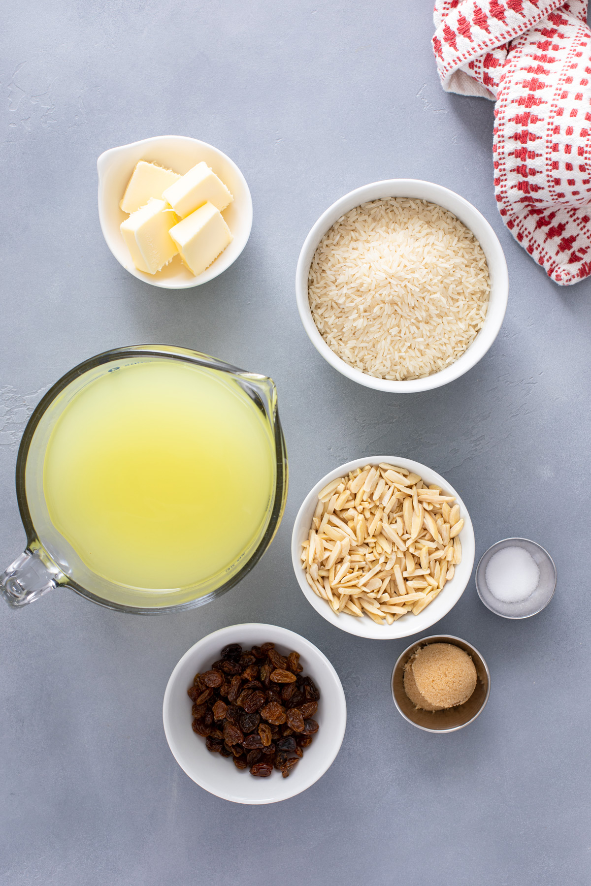 Ingredients for almond rice pilaf on a gray countertop.