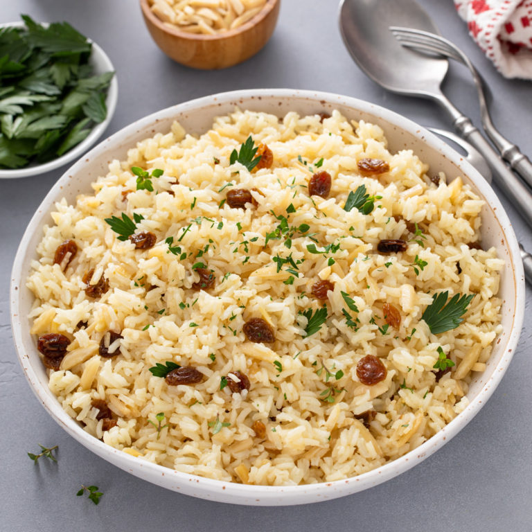 White bowl filled with almond rice pilaf.