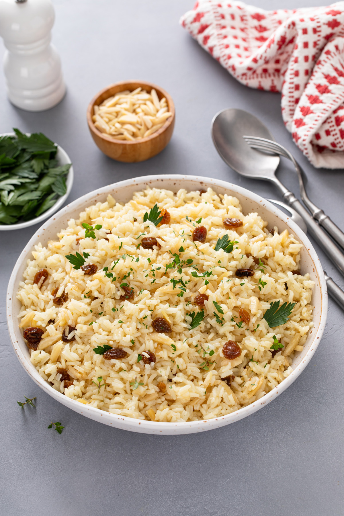 Almond rice pilaf in a large white serving bowl.