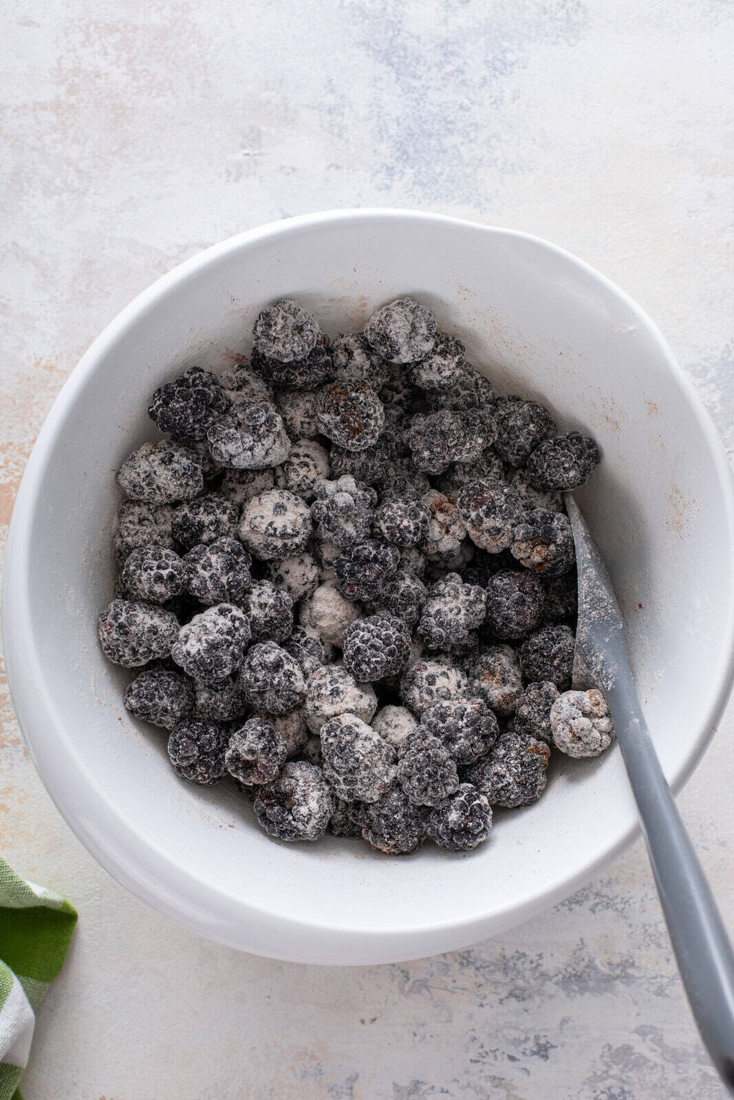 Fresh blackberries mixed with flour, sugar, and cinnamon.