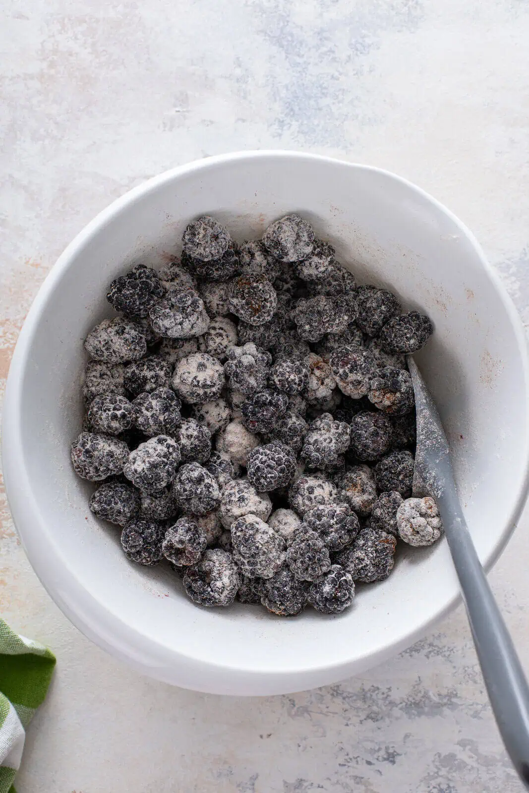 Fresh blackberries mixed with flour, sugar, and cinnamon.