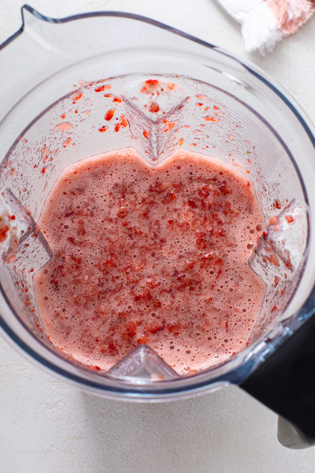 Pureed strawberry mixture in a blender pitcher.