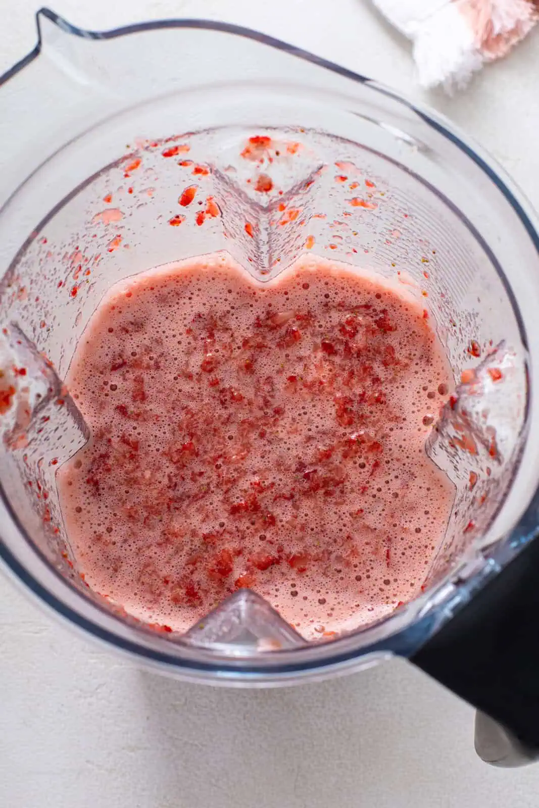 Pureed strawberry mixture in a blender pitcher.