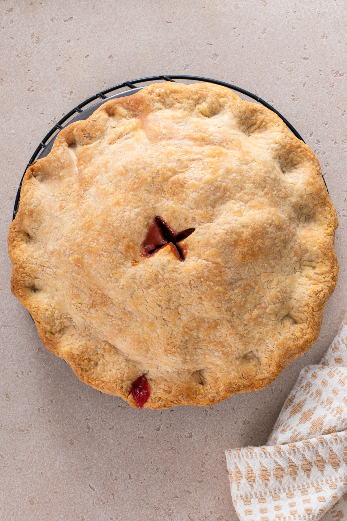 Baked raspberry rhubarb pie on a countertop.