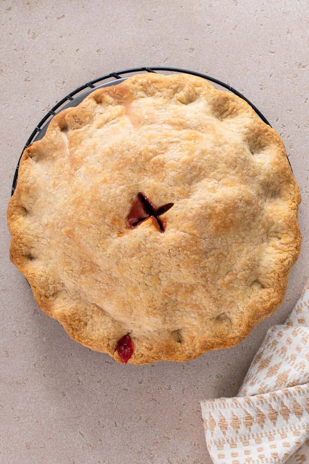 Baked raspberry rhubarb pie on a countertop.