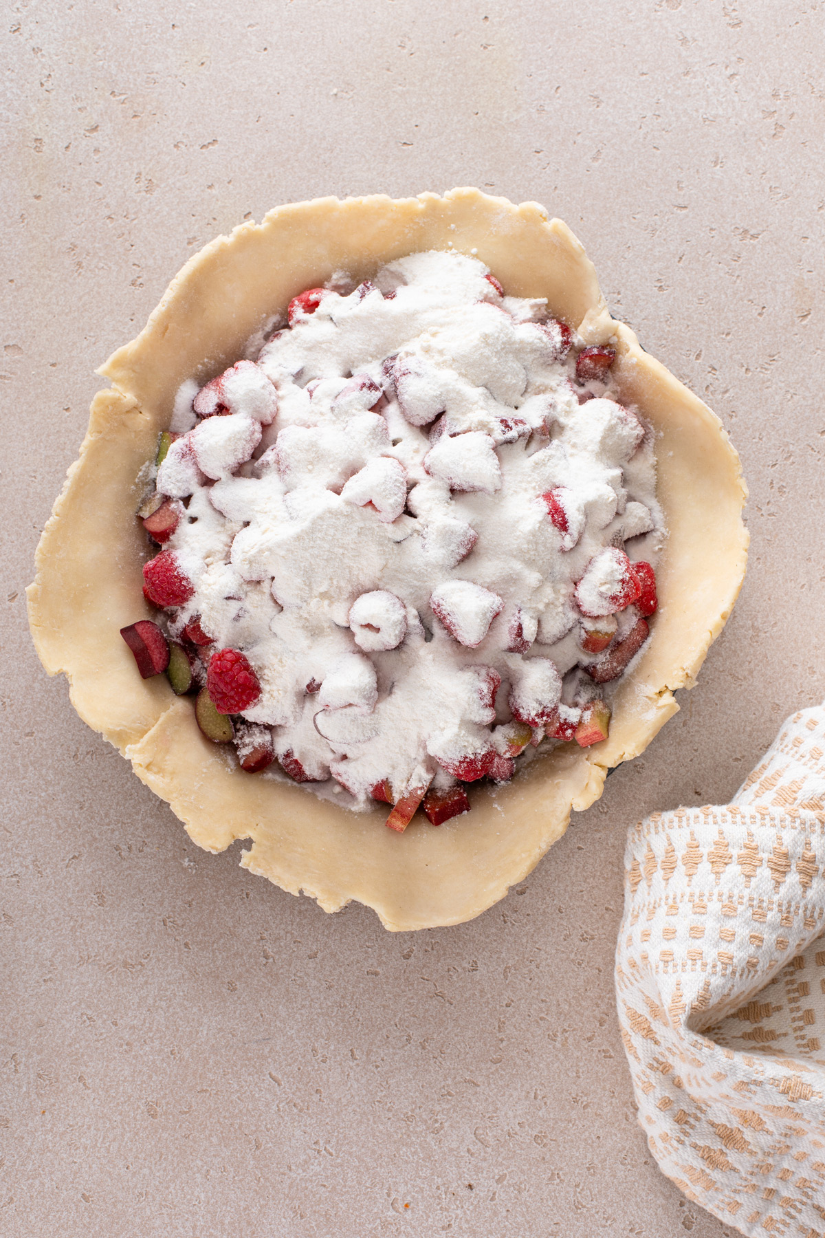 Raspberry rhubarb pie filling assembled in a pie crust.