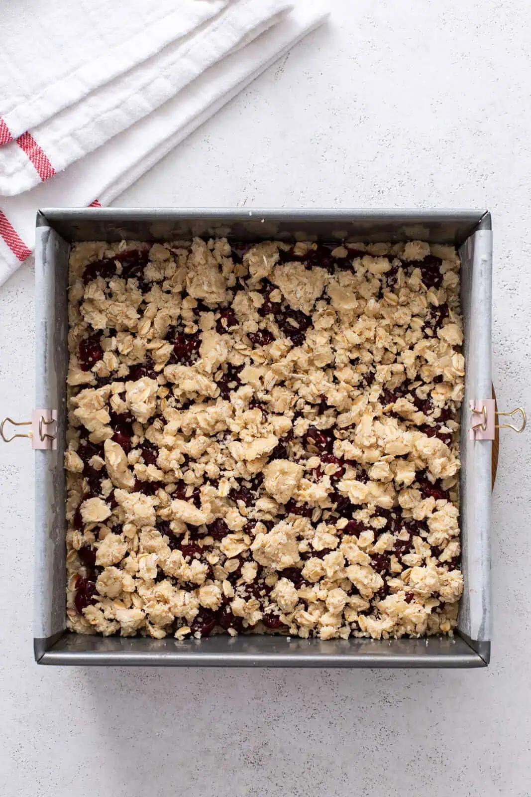 Unbaked cherry bars in a pan, ready to go in the oven.