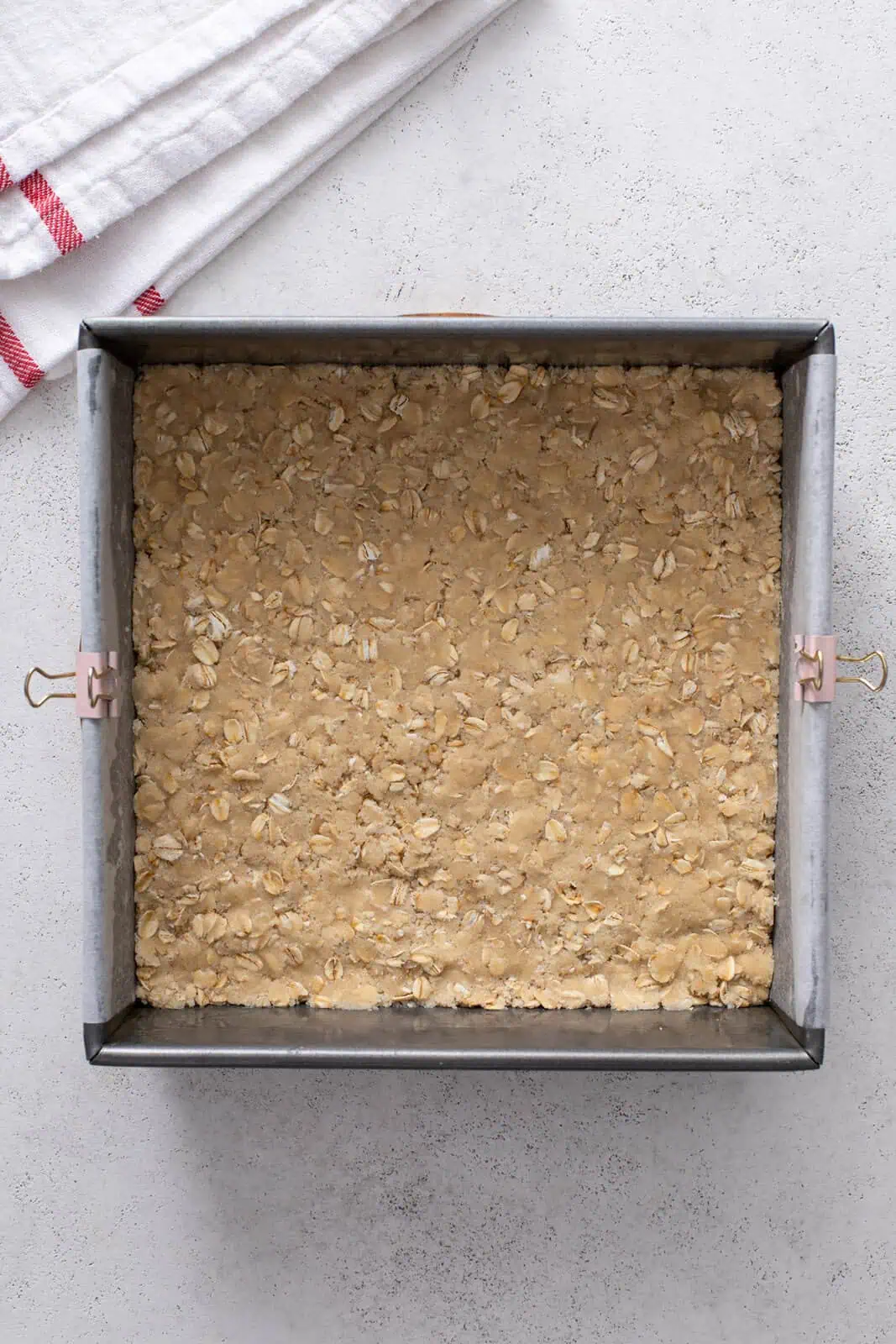 Bottom crust for cherry bars pressed into a baking pan.