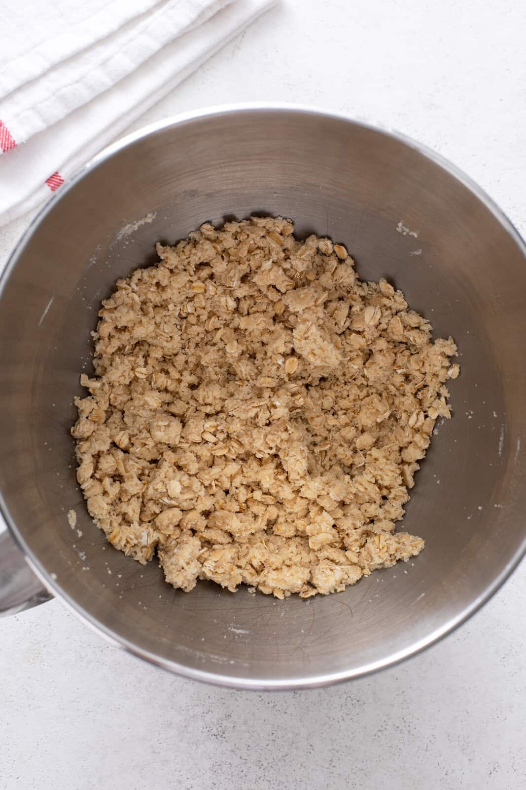 Dough mixture for cherry bar crust in a metal bowl.