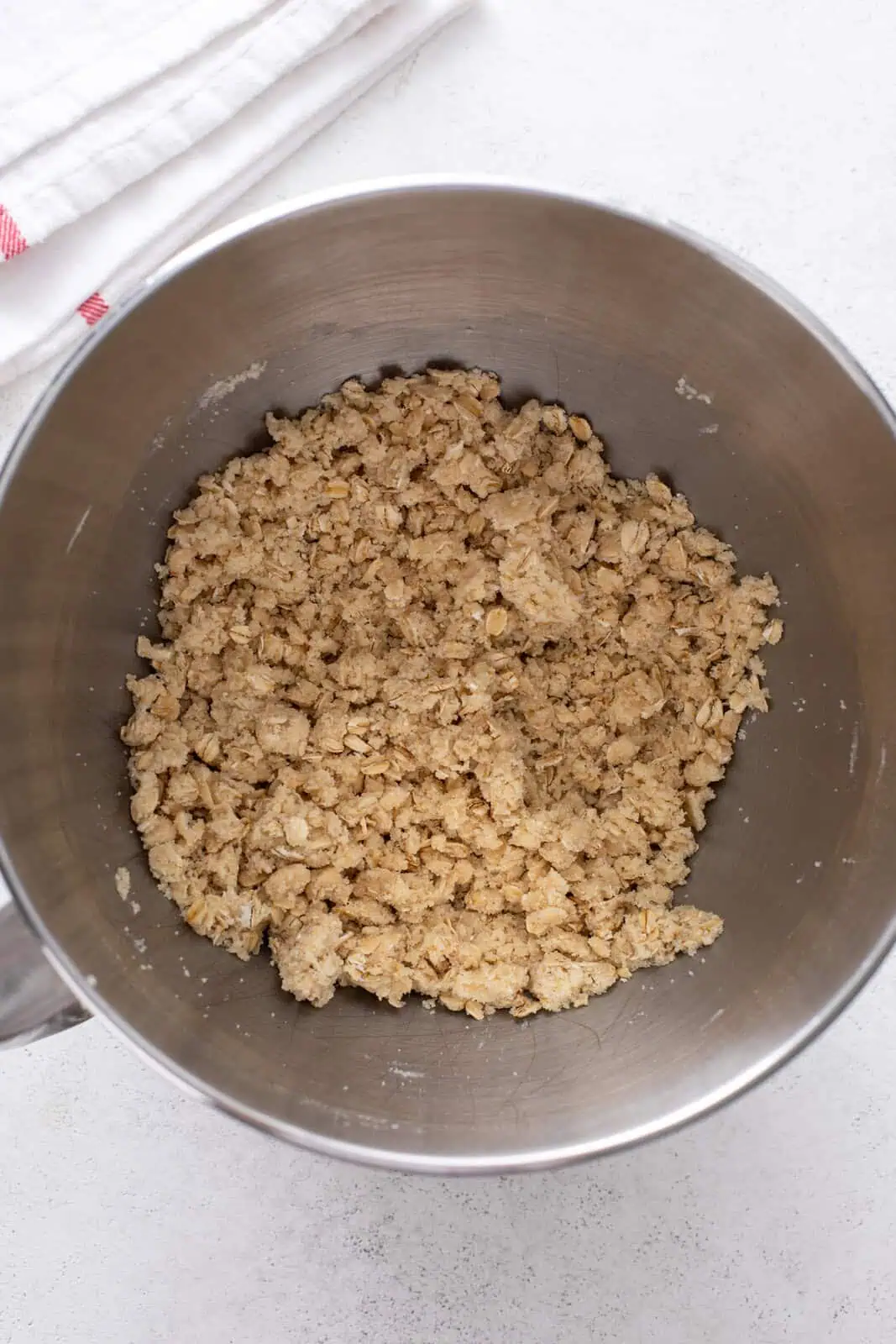 Dough mixture for cherry bar crust in a metal bowl.