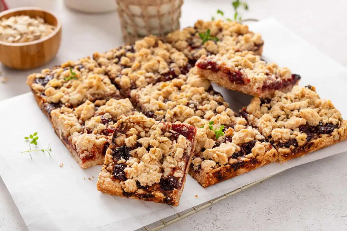 Sliced sour cherry bars arranged on a piece of parchment paper.