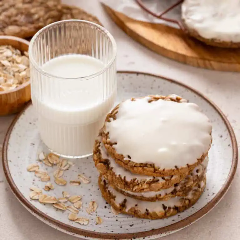 Plated iced oatmeal cookies with a glass of milk.