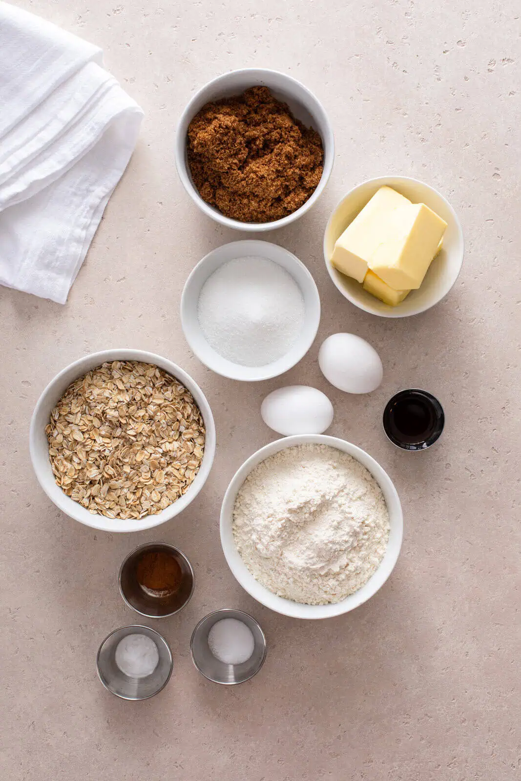 Ingredients for oatmeal cookies arranged on a countertop.