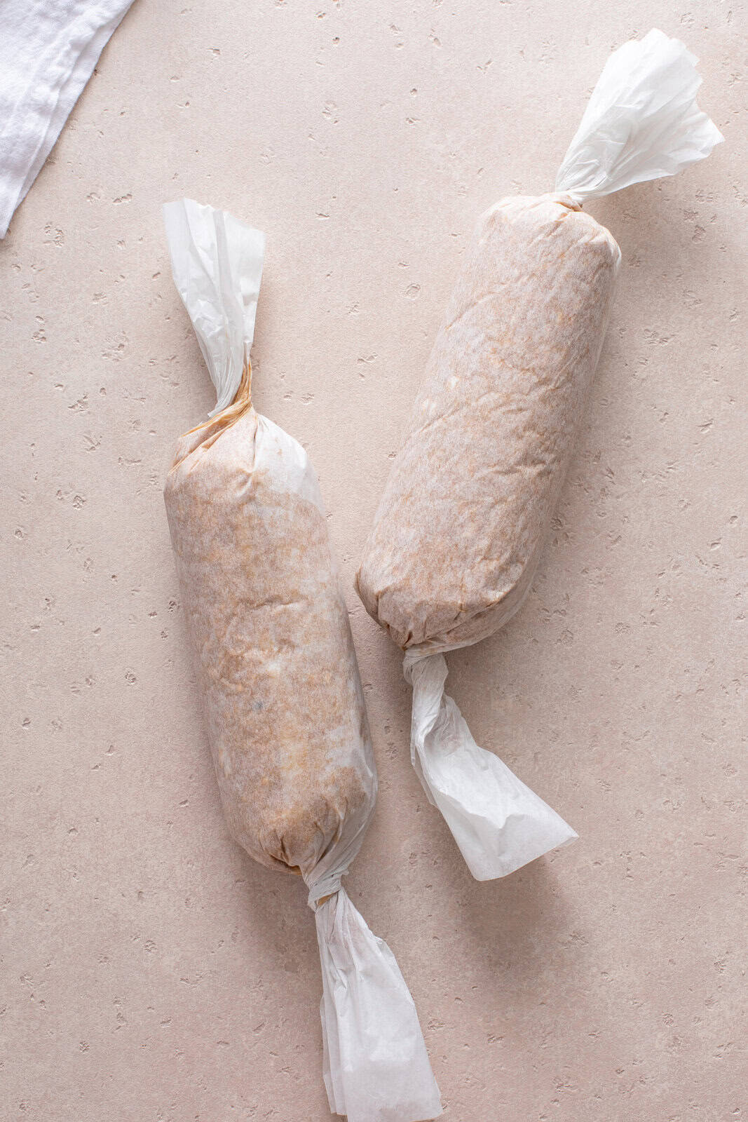 Oatmeal cookie dough wrapped in parchment into logs.
