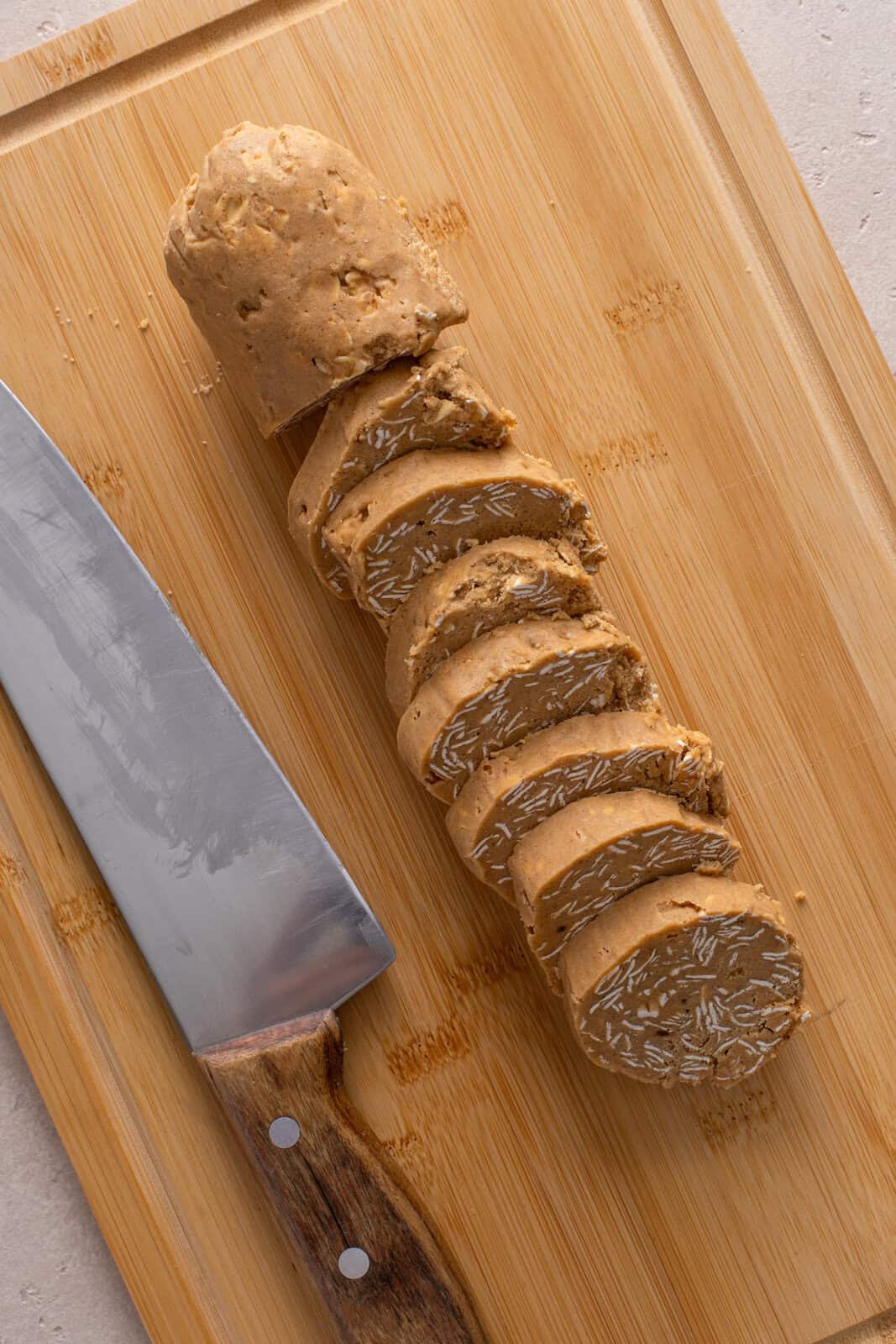 Oatmeal cookie dough log cut into slices.