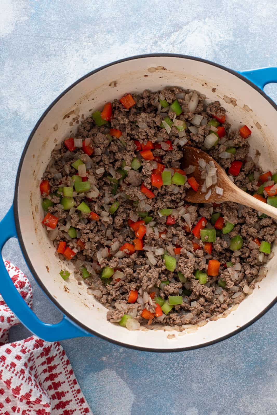 Cooked ground beef, onions, and bell peppers in a dutch oven.