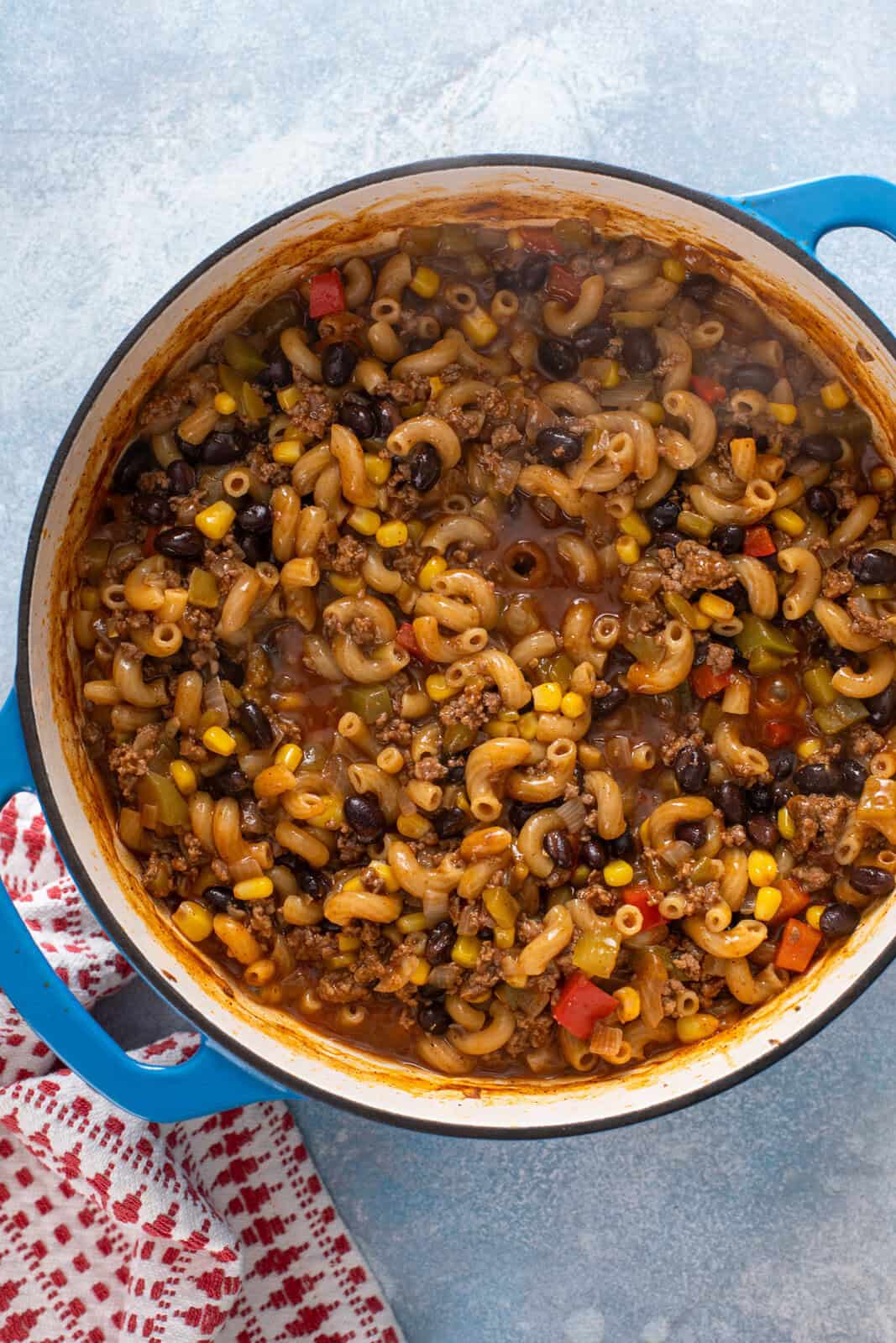 Cooked enchilada pasta in a blue dutch oven.