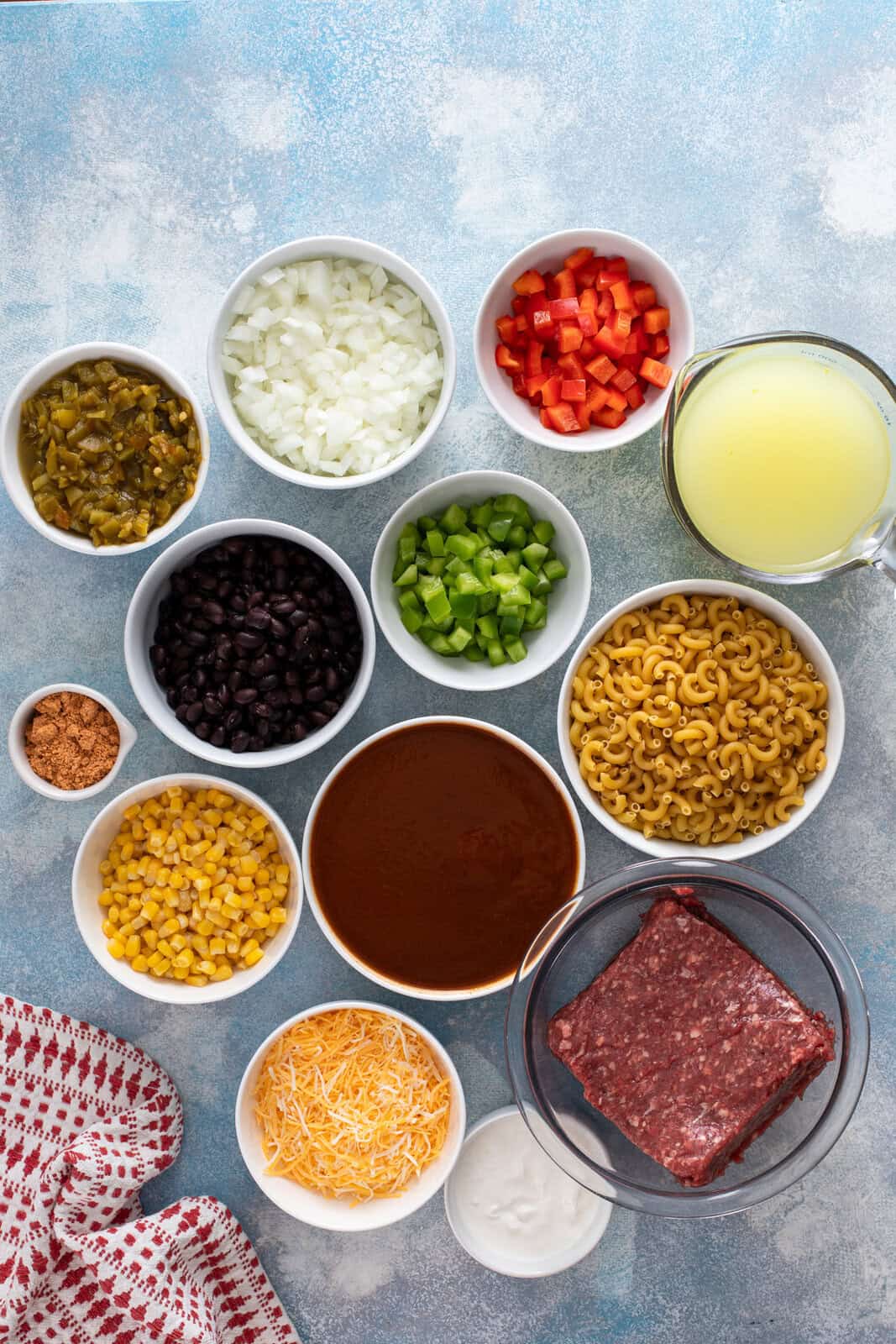 Ingredients for enchilada pasta arranged on a countertop.