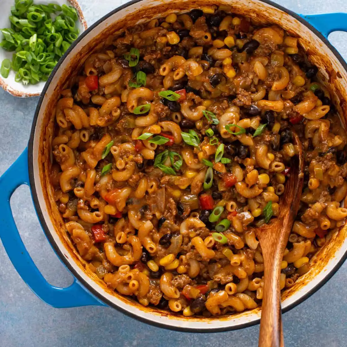 Overhead view of enchilada pasta in a blue dutch oven.