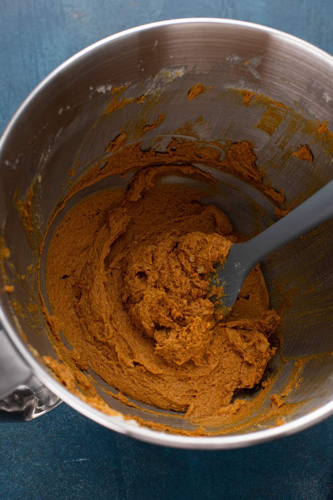 Butter, sugar, and molasses creamed together in a bowl.