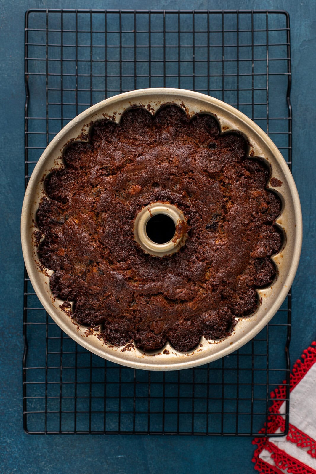 Baked fruitcake cooling on a wire rack.