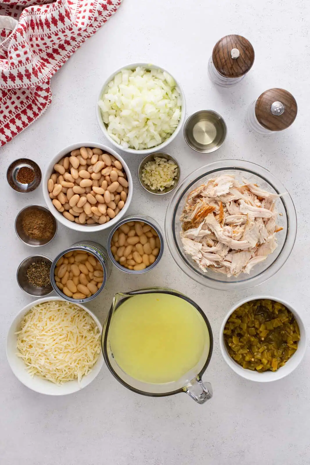Overhead view of ingredients for white bean chicken chili arranged on a countertop.