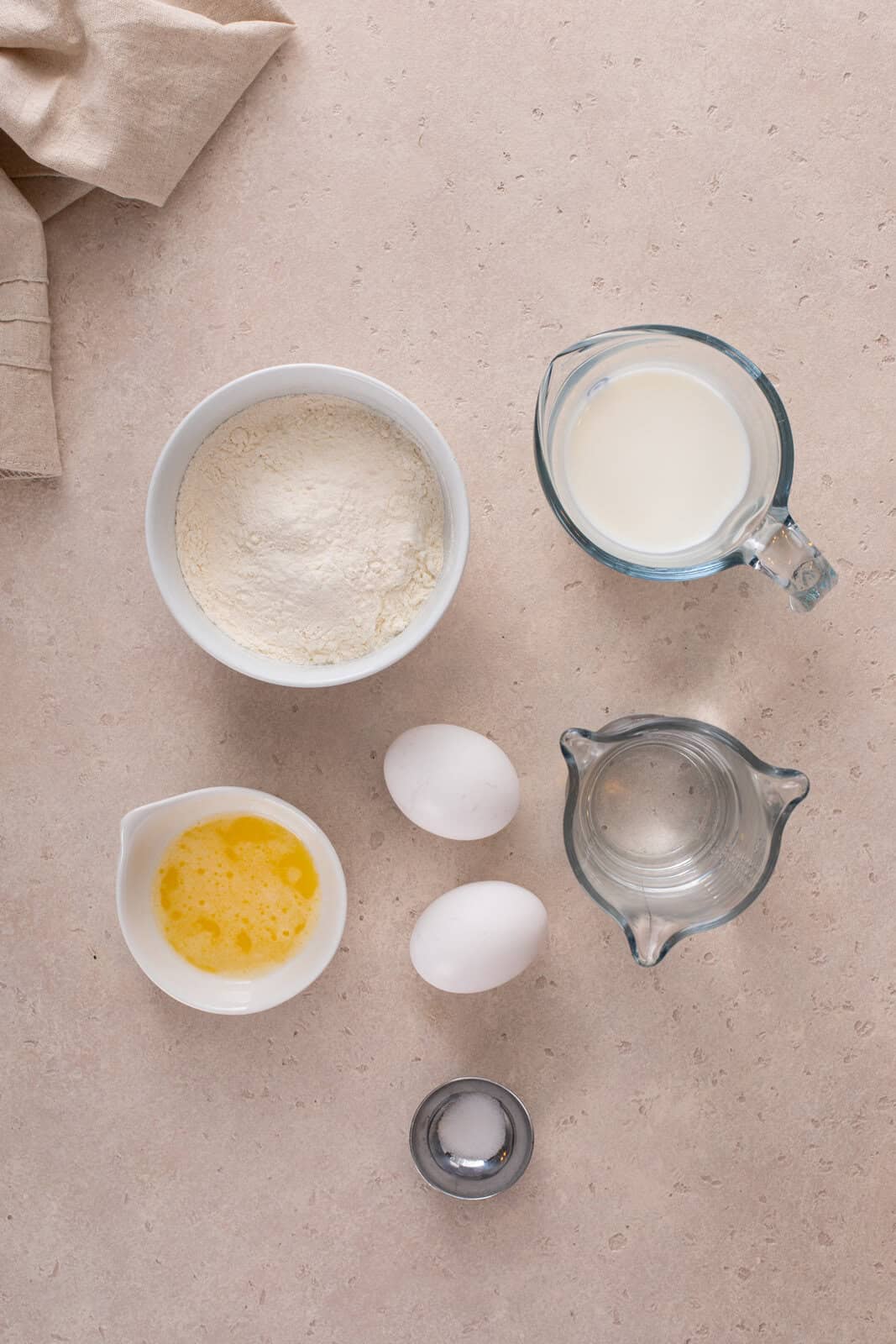 Ingredients for easy crepes arranged on a countertop.