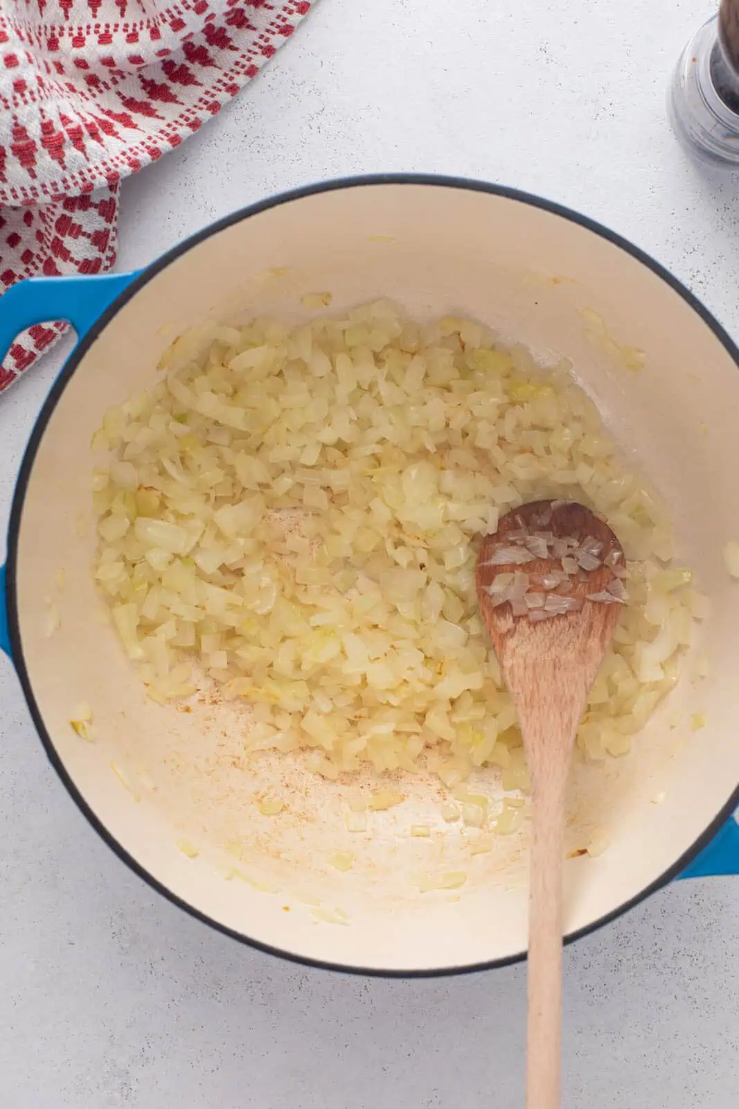 Onion being sauteed in a dutch oven.