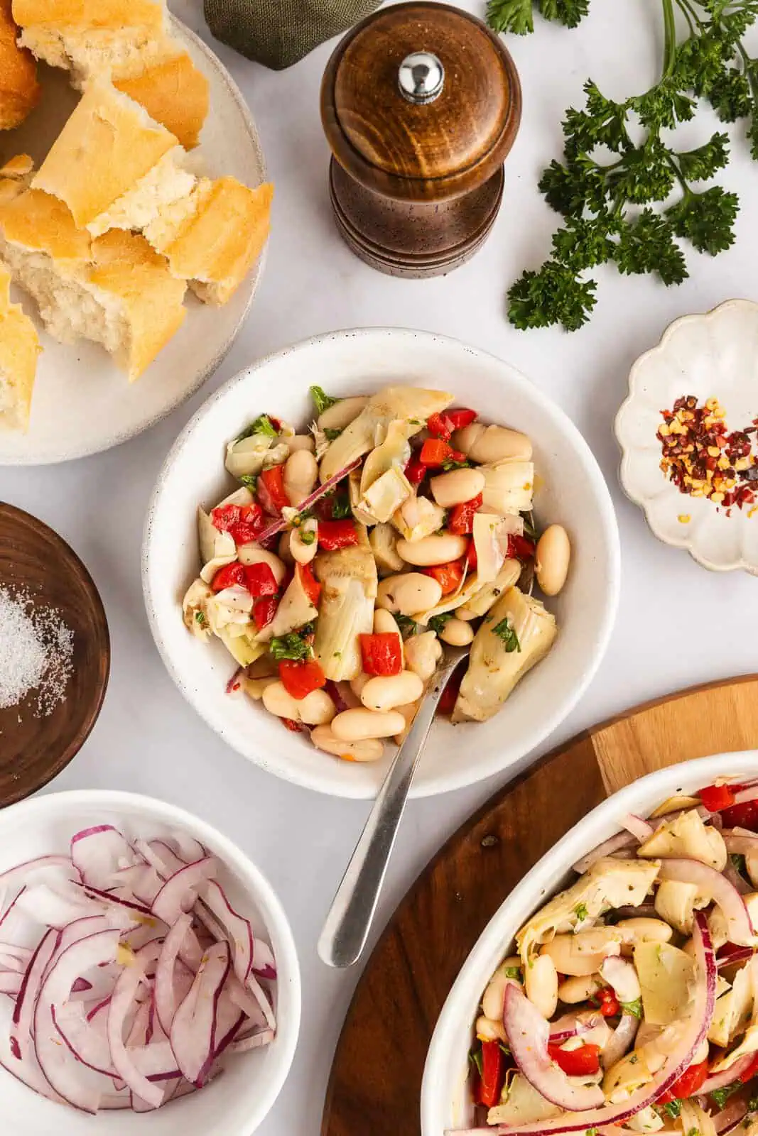 Overhead view of white bean and artichoke salad on a countertop.
