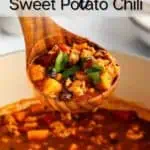 Wooden ladle lifting up a serving of turkey sweet potato chili. Text overlay includes recipe name.