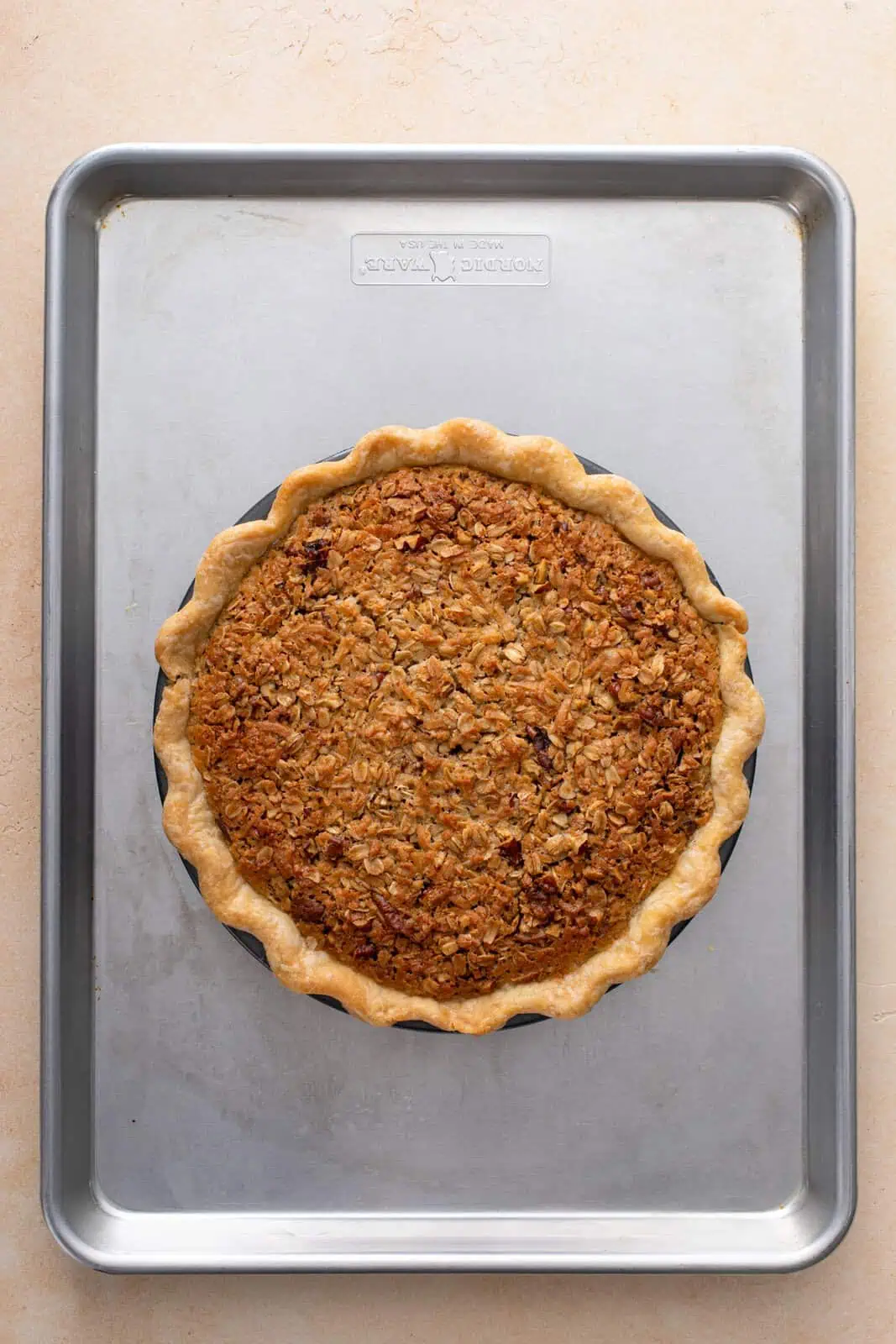 Baked oatmeal pie on a rimmed baking sheet.