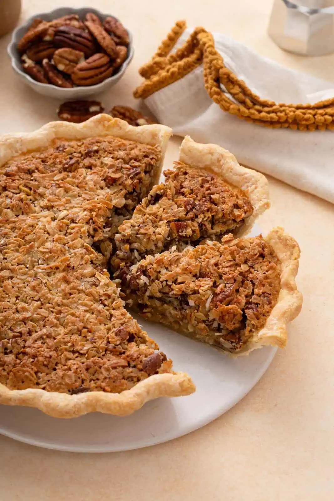 Sliced oatmeal pie on a white platter with one of the slices removed.