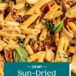 Close up of sun-dried tomato pasta garnished with fresh basil. Text overlay includes recipe name.