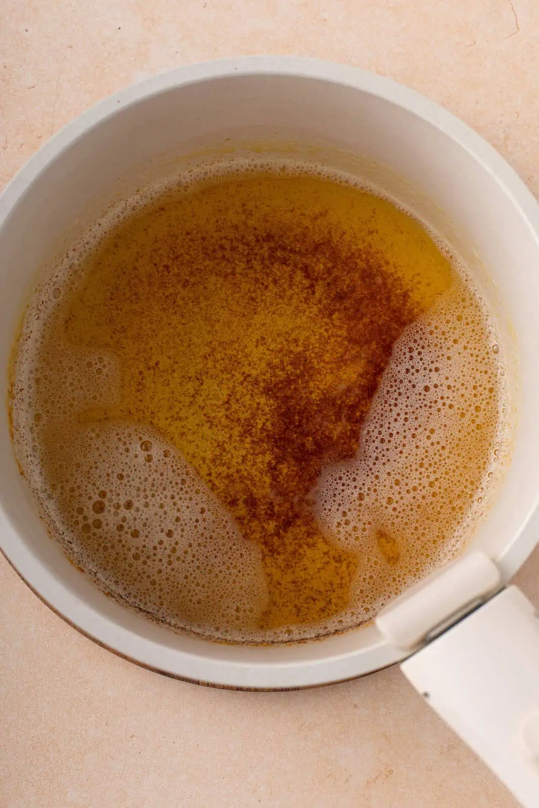 Browned butter in a white saucepan.