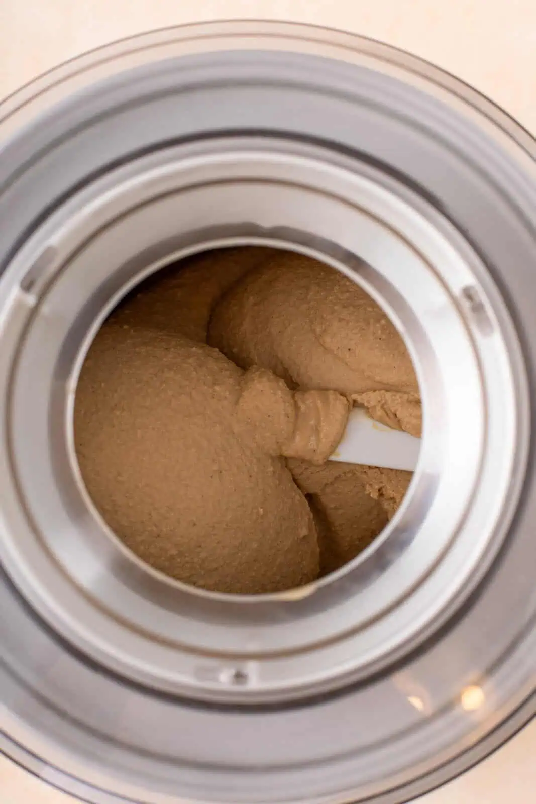 Churned butter pecan ice cream base in an ice cream maker.