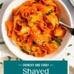 Overhead view of a fork in a white bowl of shaved carrot salad. Text overlay includes recipe name.