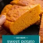 Hand picking up a slice of sweet potato cornbread from a skillet. Text overlay includes recipe name.