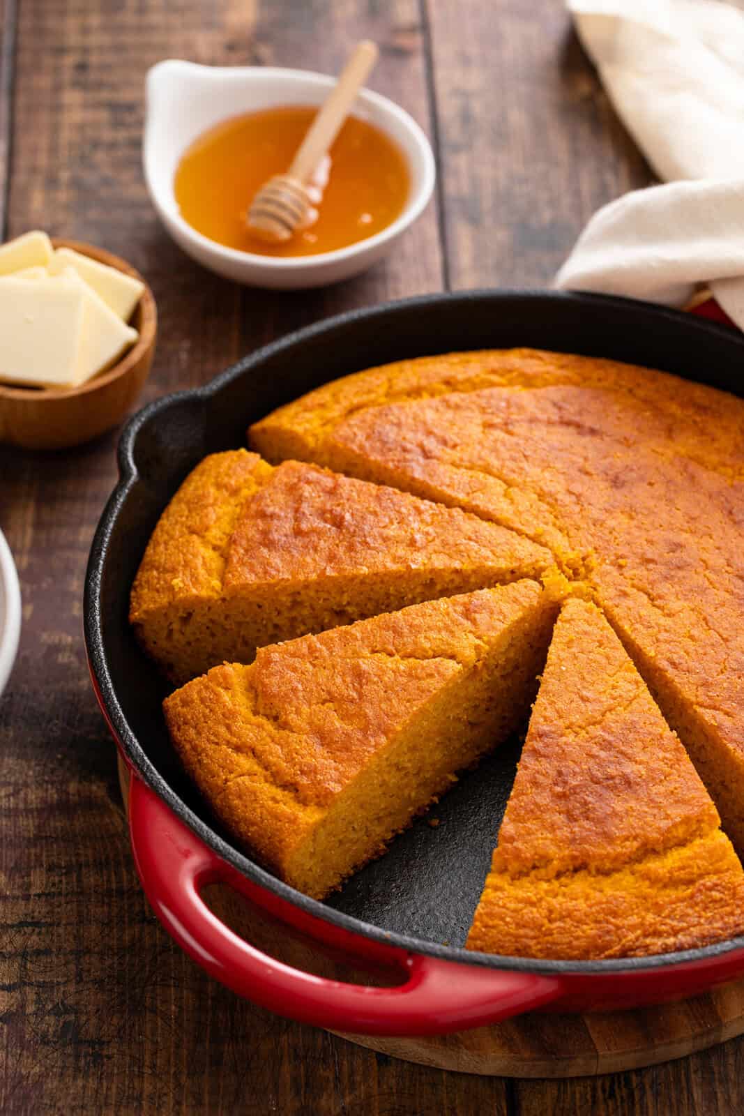 Sliced sweet potato cornbread in a cast iron skillet.