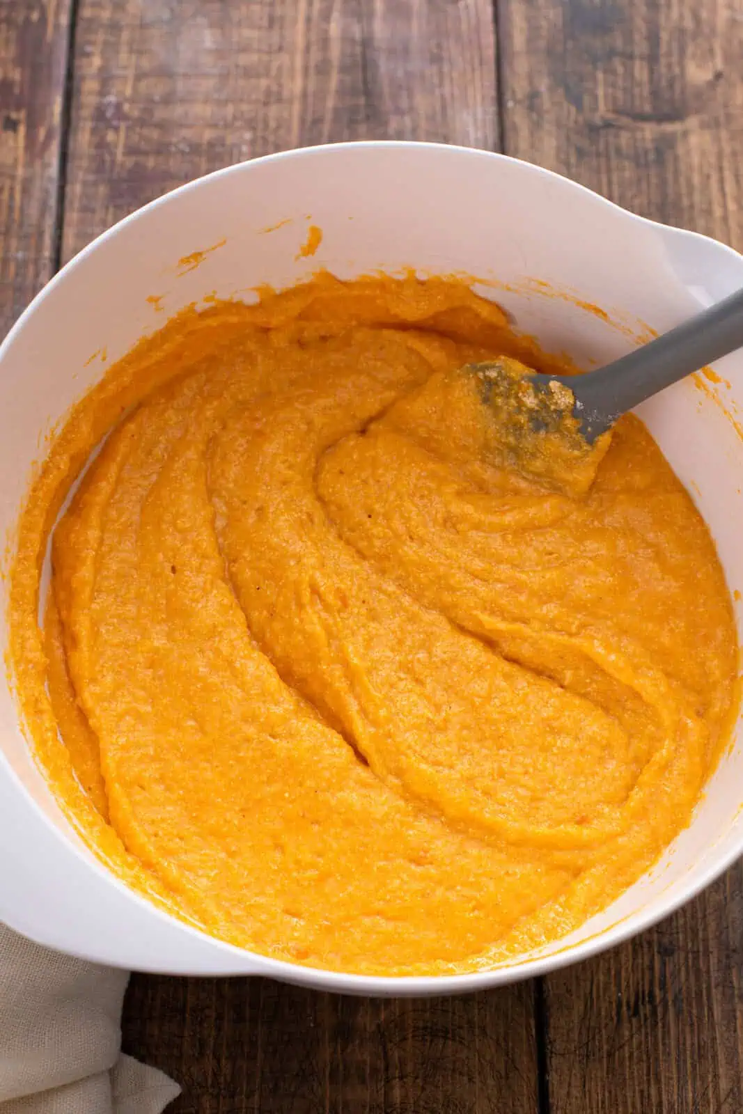 Batter for sweet potato cornbread mixed in a white bowl.