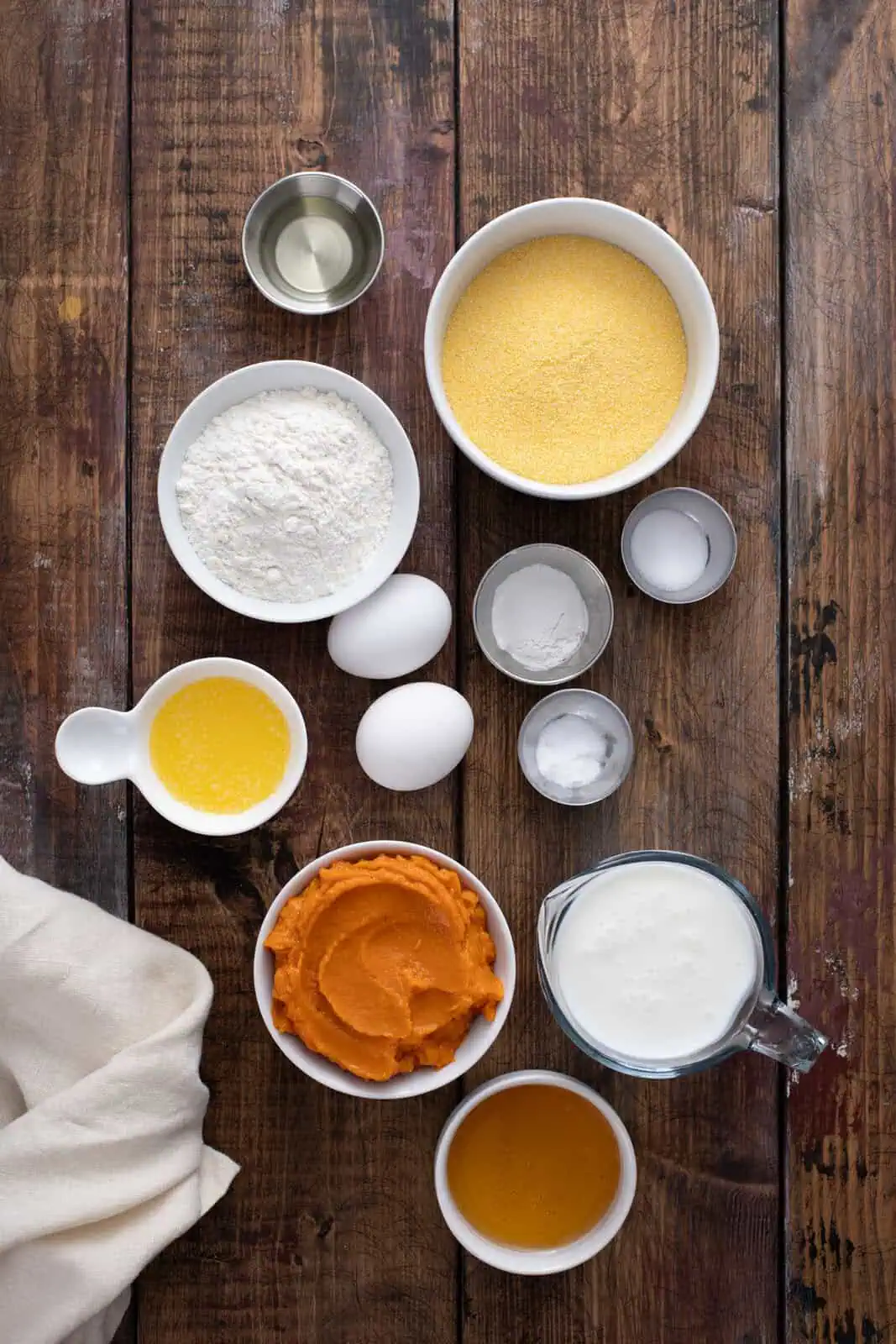 Ingredients for sweet potato cornbread arranged on a table.