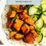 Close up of air fryer salmon bites and sliced cucumbers on a bed of white rice. Text overlay includes recipe name.