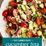 Serving platter filled with cucumber feta salad. Text overlay includes recipe name.