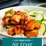 White bowl filled with rice, cucumbers, and air fryer salmon bites. Text overlay includes recipe name.