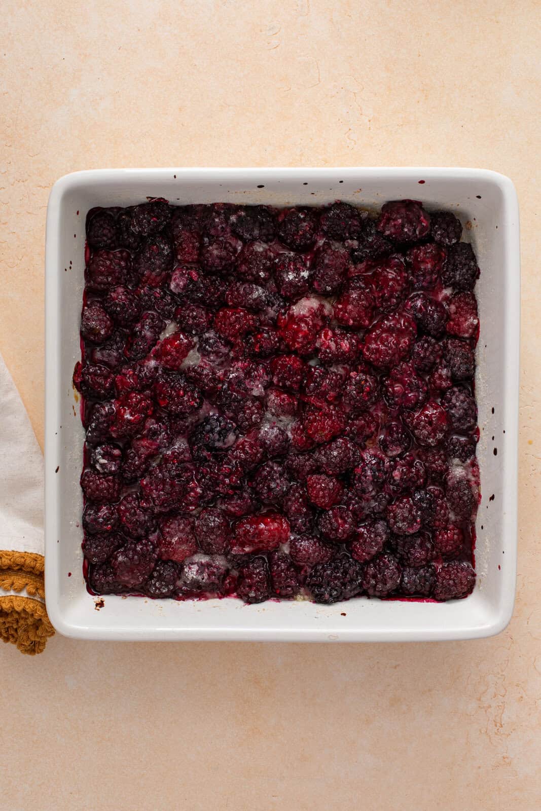 Par-baked blackberry filling in a baking dish.
