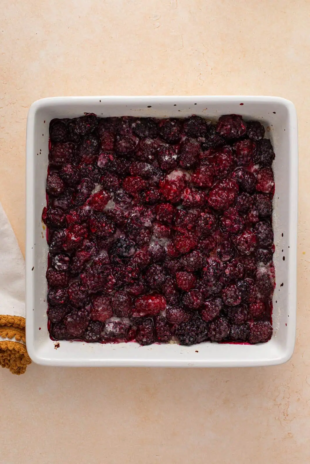 Par-baked blackberry filling in a baking dish.