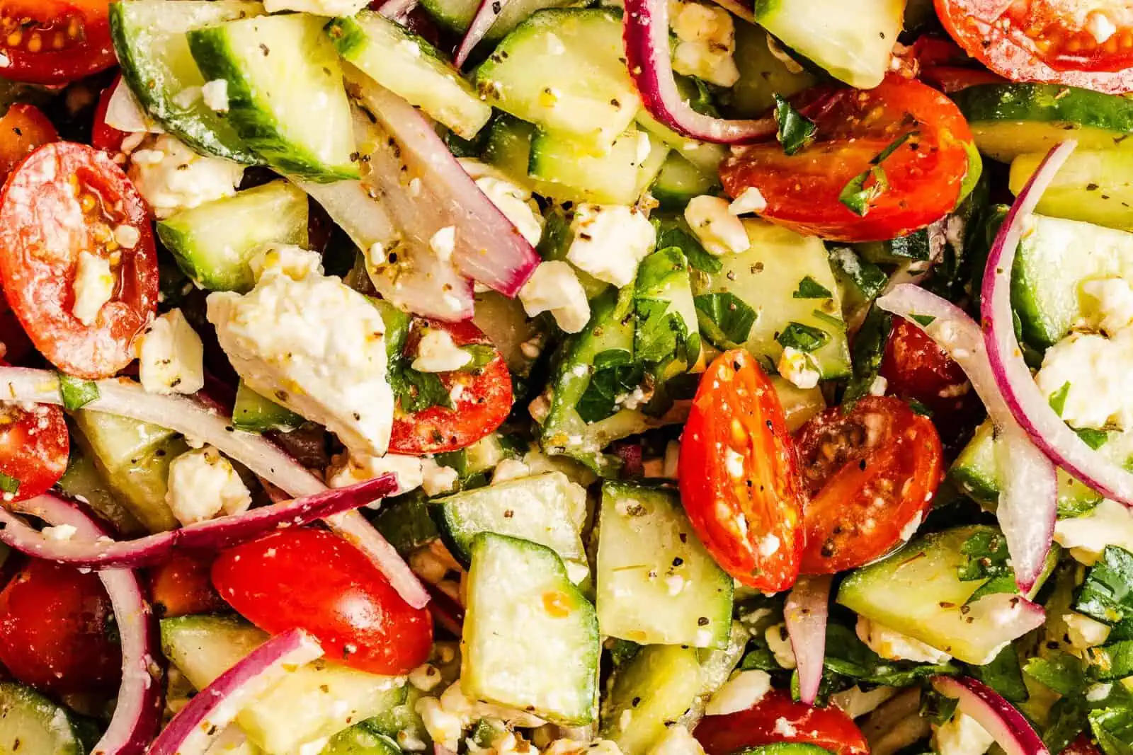Close up of dressed cucumber feta salad.