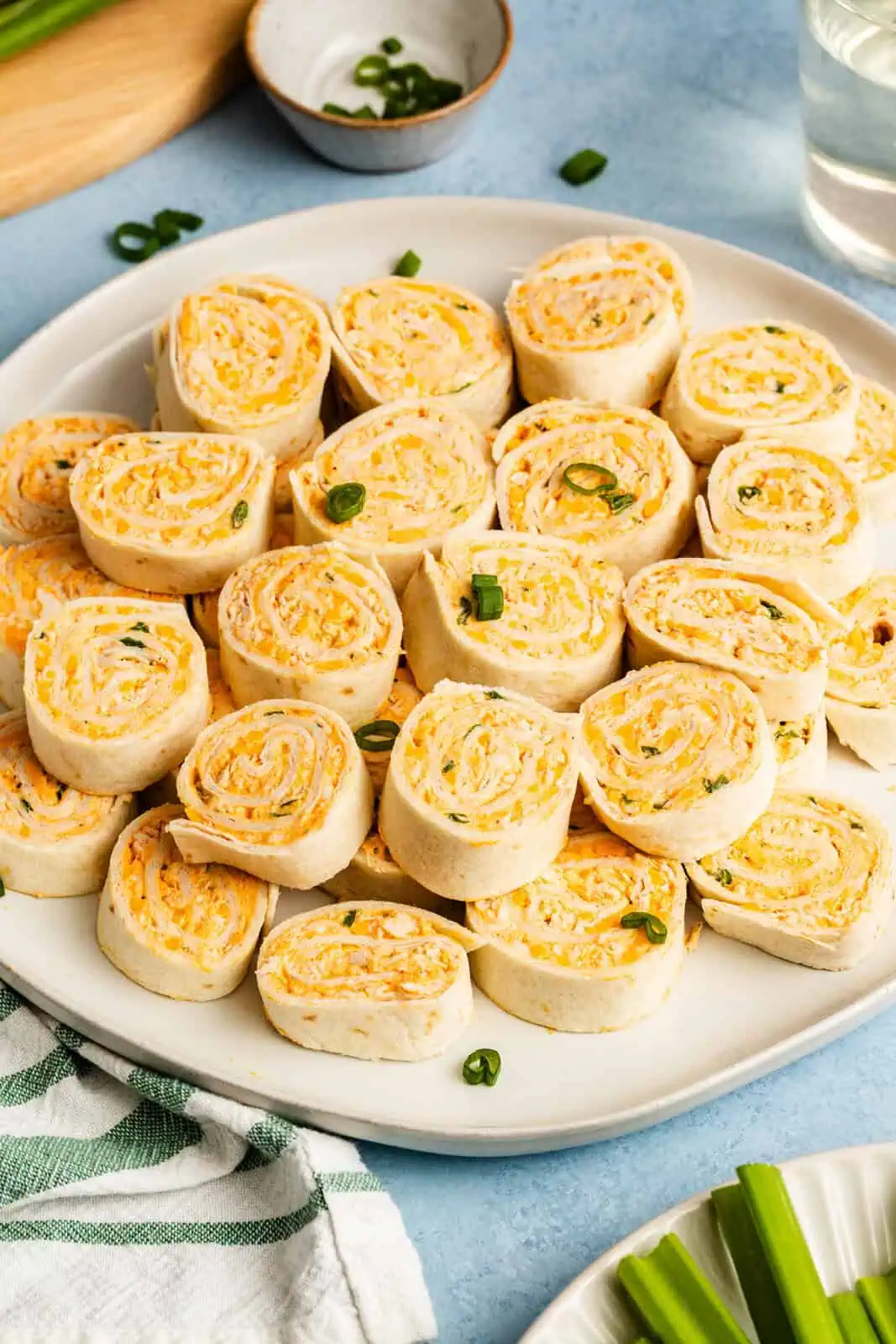 Sliced buffalo chicken pinwheels arranged on a white platter.